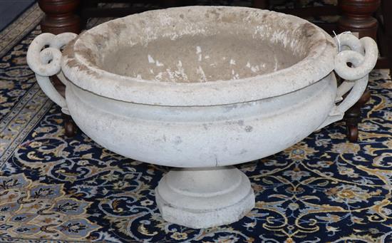 A reconstituted stone garden urn with intertwined handles, on short plinth (a.f.) W.85cm